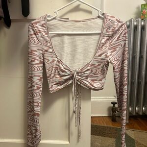 Tight brownish pink and white crop top with a tie in the front